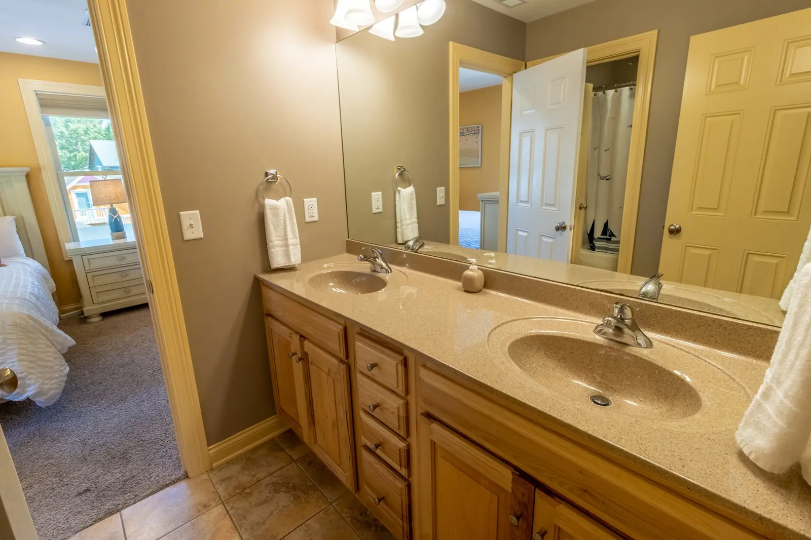 Jack-and-Jill bathroom with a double vanity and doors to both guest rooms
