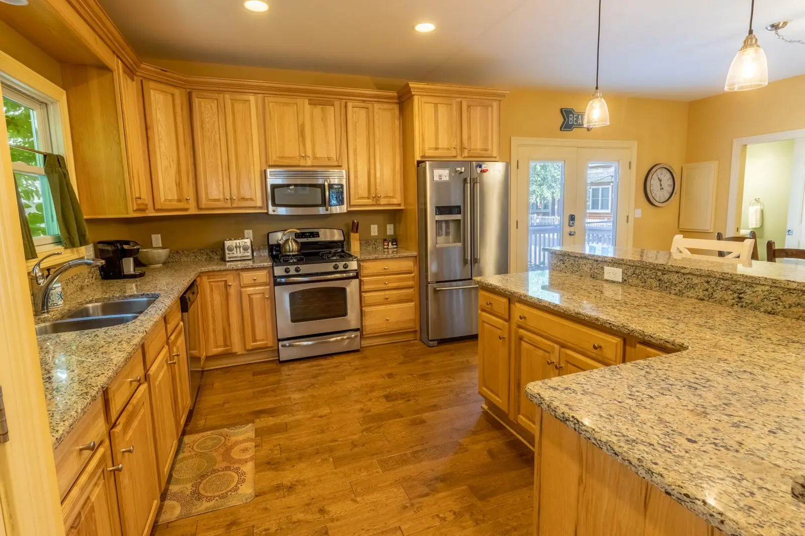 Kitchen with granite counters, wood cabinets and stainless appliances