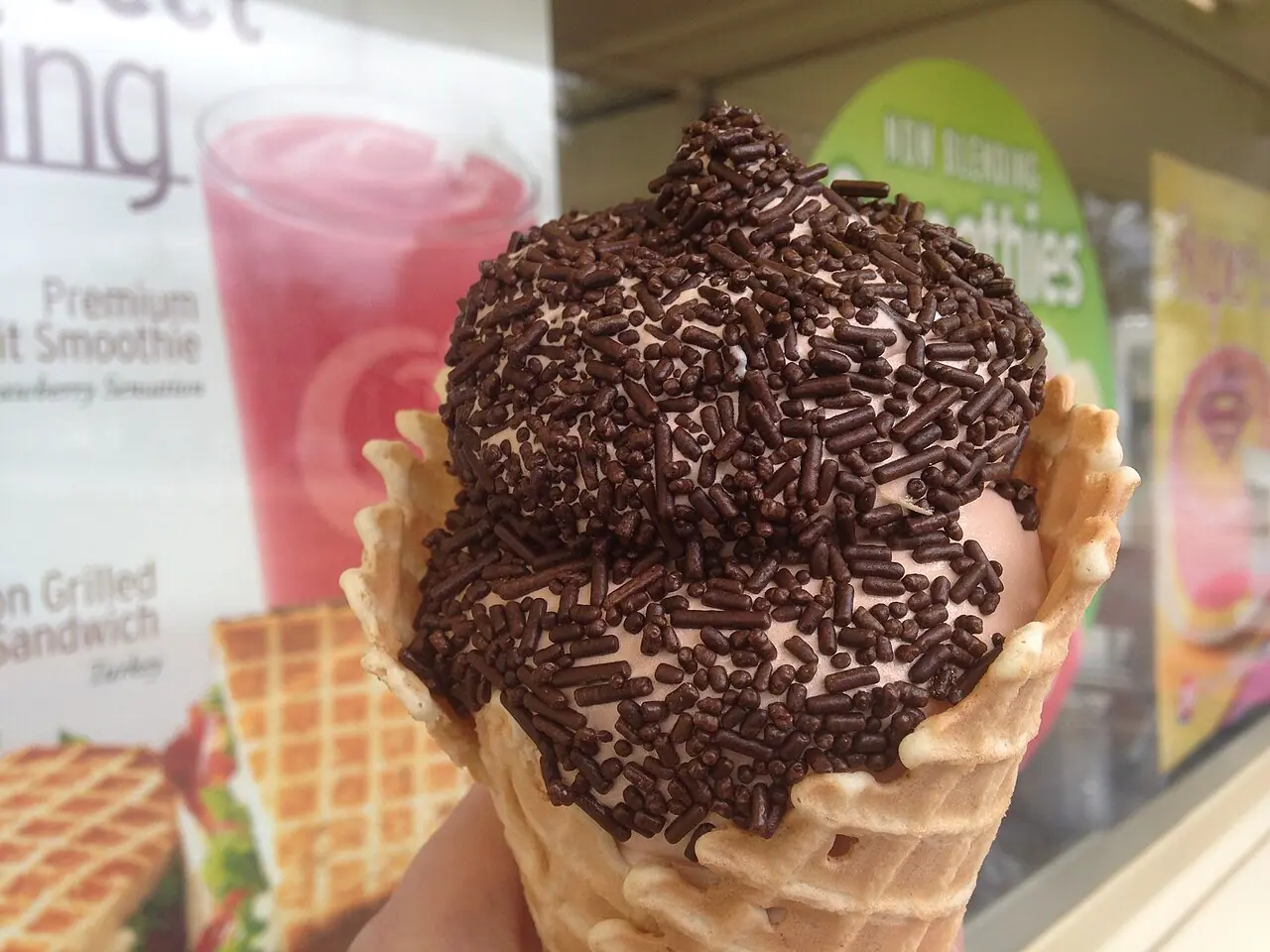 Chocolate ice cream with chocolate sprinkles in a waffle cone
