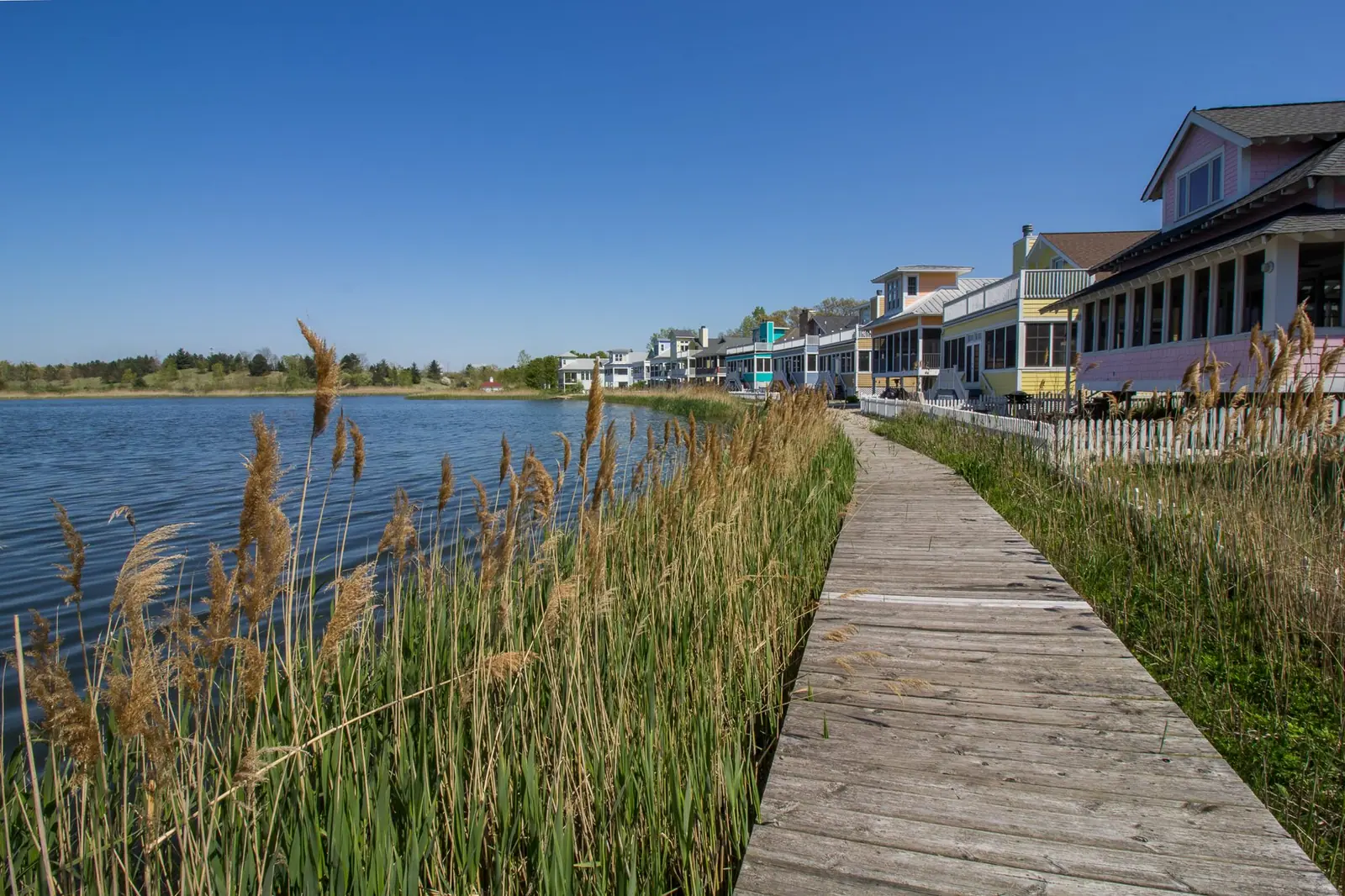 The boardwalk through beach grass along Lake Kai at Beachwalk Resort