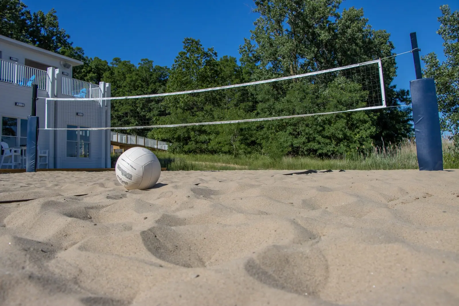 Volleyball in the sand under a beach volleyball net