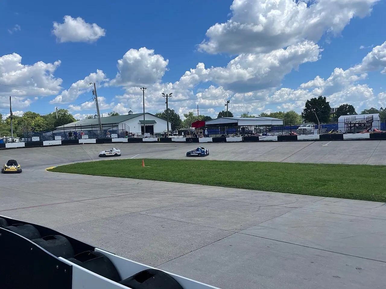 Go-karts rounding a curve on an outdoor go-kart track